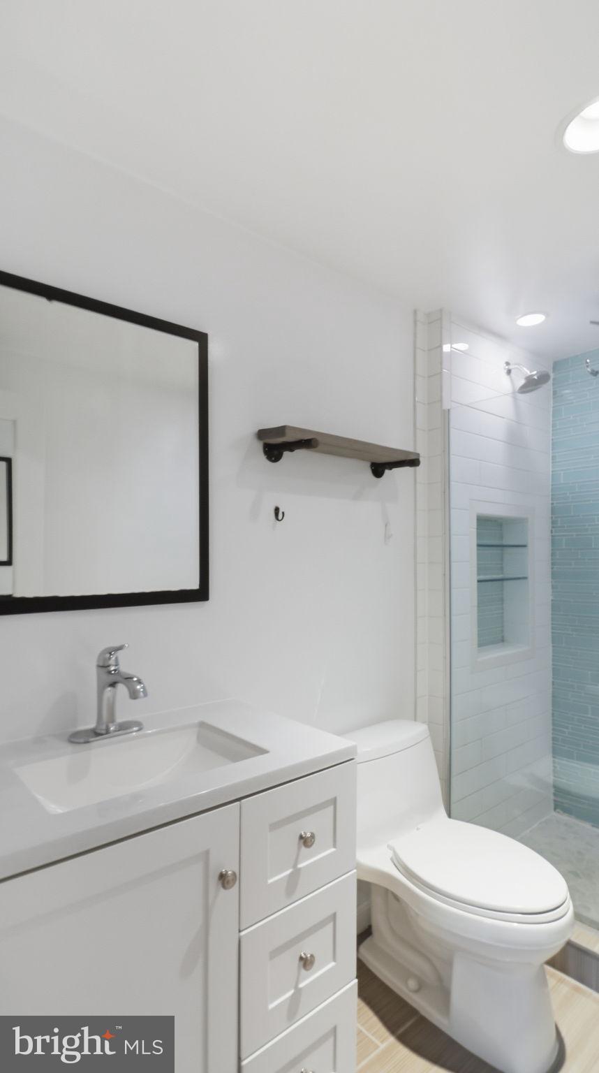 1450 Harvard Street Northwest, Unit B Washington, DC 20009 - Photo 26 of 35 a bathroom with a sink a toilet and shower