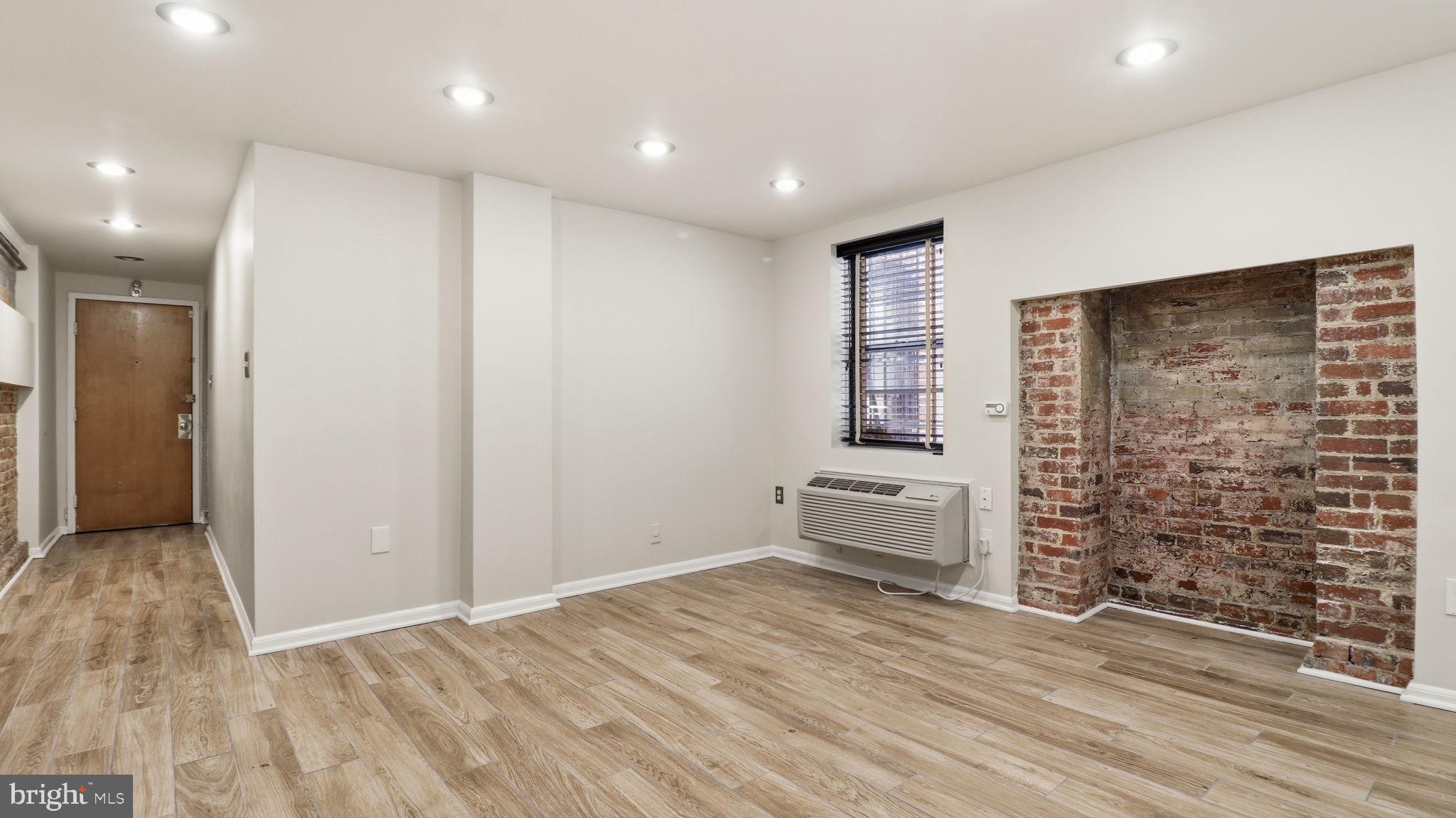 1450 Harvard Street Northwest, Unit B Washington, DC 20009 - Photo 6 of 35 an empty room with wooden floor and windows