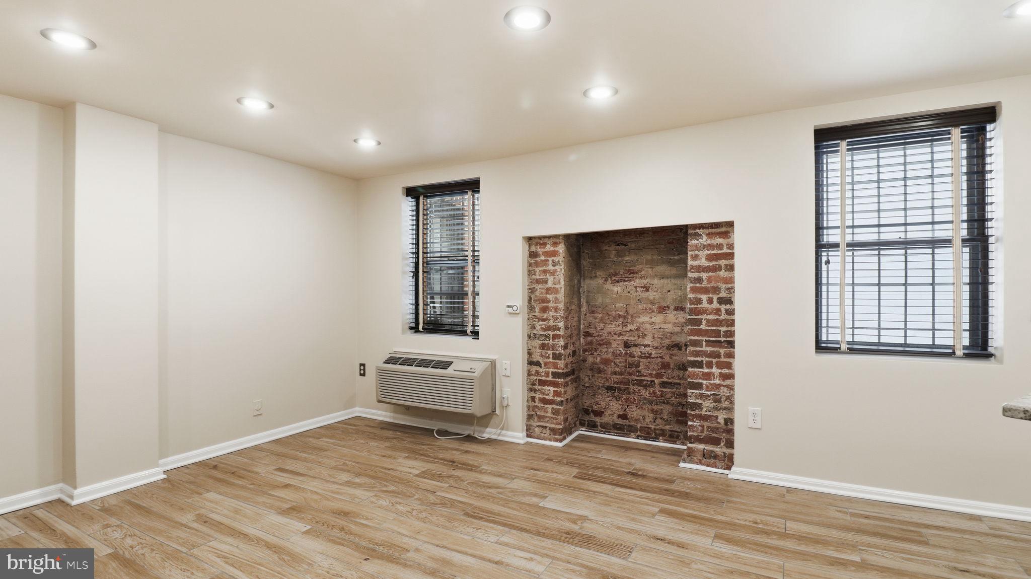 1450 Harvard Street Northwest, Unit B Washington, DC 20009 - Photo 7 of 35 an empty room with wooden floor and windows