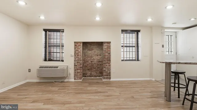 an empty room with windows and cabinet