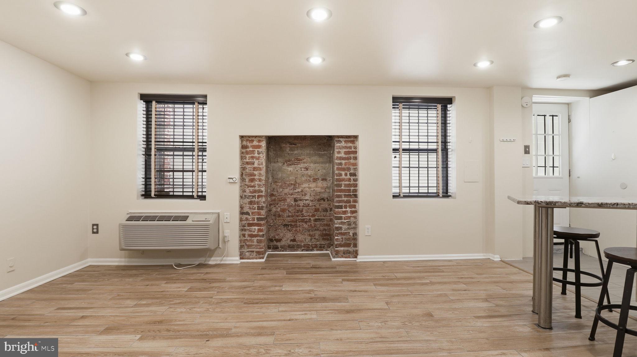 1450 Harvard Street Northwest, Unit B Washington, DC 20009 - Photo 9 of 35 an empty room with windows and cabinet
