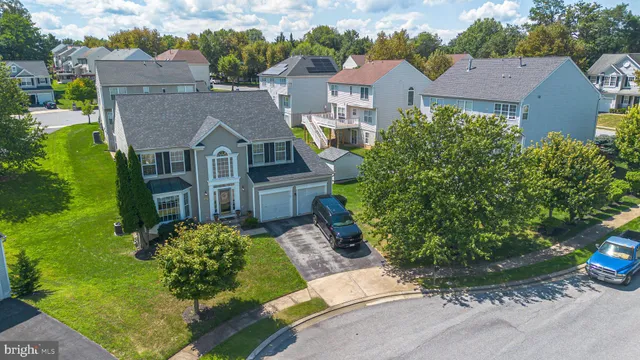 an aerial view of a house with a yard