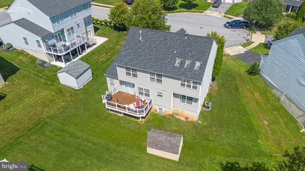 an aerial view of residential house with outdoor space and swimming pool