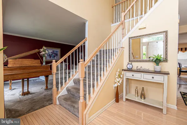 a view of entryway and hall with wooden floor