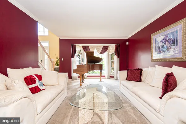 a living room with furniture and a painting