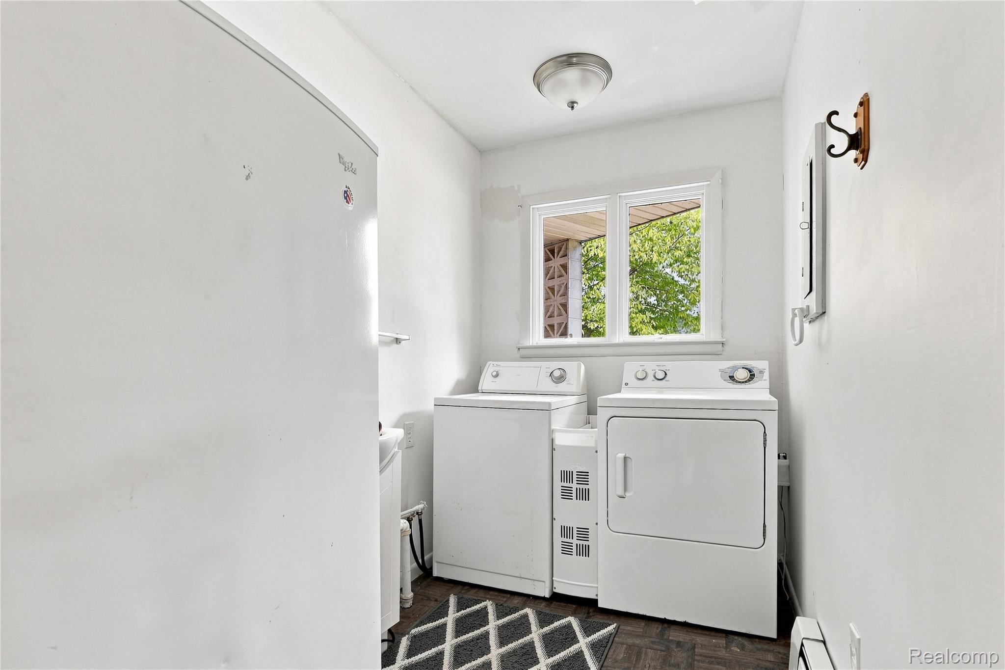 7386 Dean Road Fenton, MI 48430 - Photo 28 of 64 Dedicated laundry area featuring a window, built-in light fixture, and wood-finish flooring