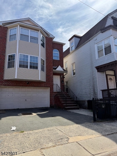a front view of a house with a parking area