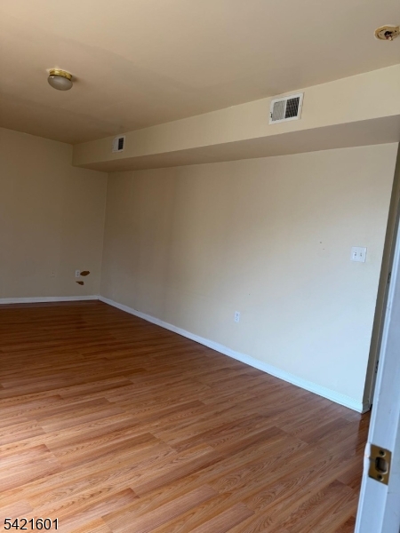 41 3rd Street Newark, NJ 07107 - Photo 11 of 31 a view of an empty room with wooden floor