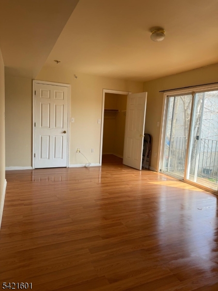 41 3rd Street Newark, NJ 07107 - Photo 12 of 31 a view of an empty room with wooden floor and a window