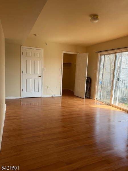 41 3rd Street Newark, NJ 07107 - Photo 13 of 31 a view of an empty room with wooden floor and a window