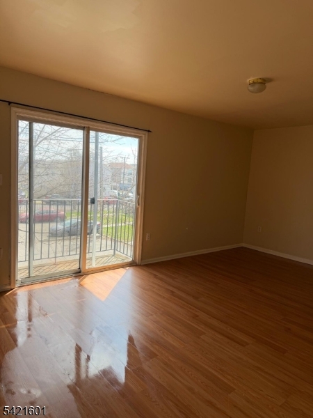41 3rd Street Newark, NJ 07107 - Photo 15 of 31 a view of an empty room with wooden floor and a window