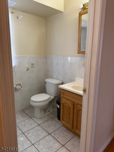41 3rd Street Newark, NJ 07107 - Photo 18 of 31 a white toilet sitting next to a bathroom sink