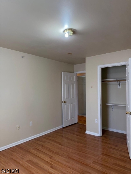 41 3rd Street Newark, NJ 07107 - Photo 25 of 31 an empty room with wooden floor & closet area