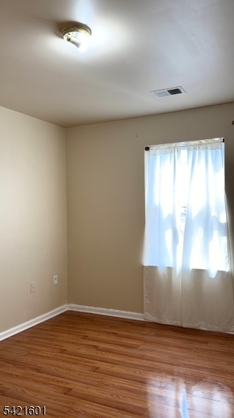 41 3rd Street Newark, NJ 07107 - Photo 29 of 31 an empty room with wooden floor and windows