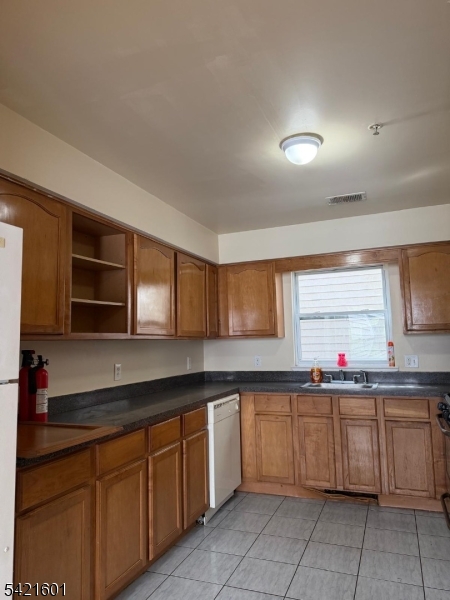 41 3rd Street Newark, NJ 07107 - Photo 4 of 31 a kitchen with a sink stove top oven and cabinets