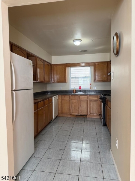 41 3rd Street Newark, NJ 07107 - Photo 6 of 31 a kitchen with stainless steel appliances granite countertop a refrigerator and a sink
