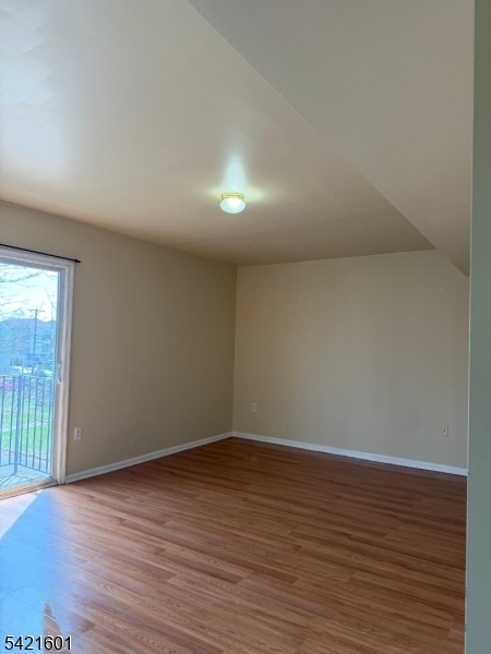 41 3rd Street Newark, NJ 07107 - Photo 8 of 31 a view of an empty room with wooden floor and a window