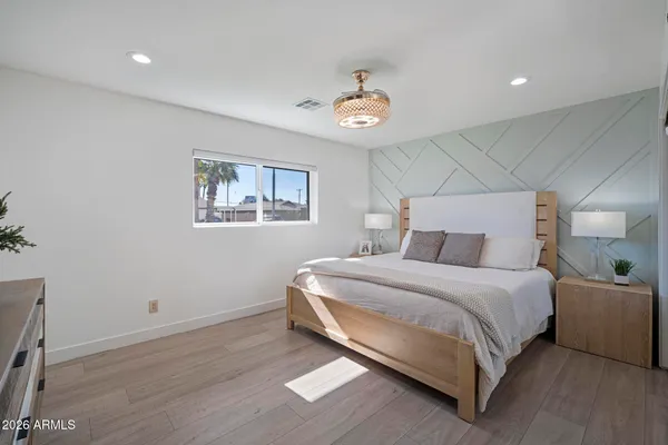 a bedroom with a bed and a chandelier