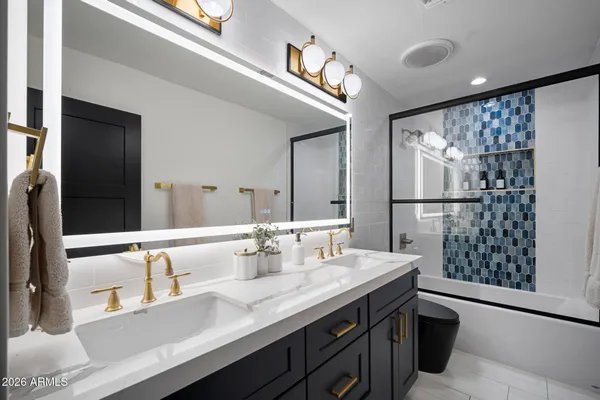 a bathroom with a granite countertop sink mirror and double