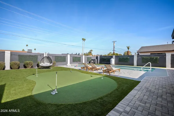 a view of a swimming pool with lounge chairs