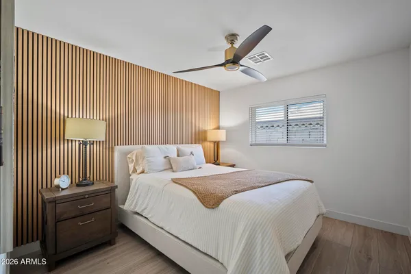 a bedroom with a bed and a window