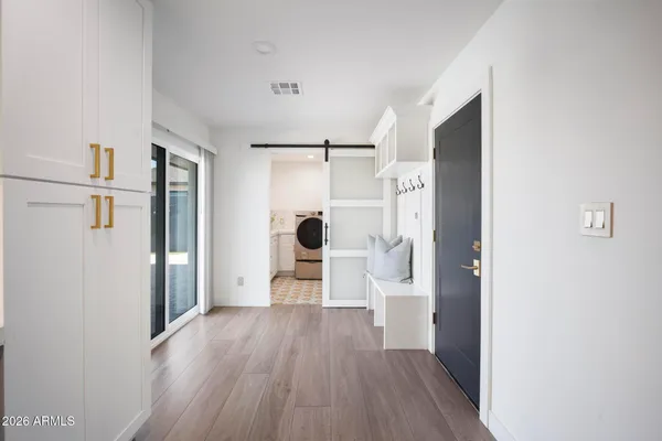 a view of bathroom with a toilet a sink and wooden floor