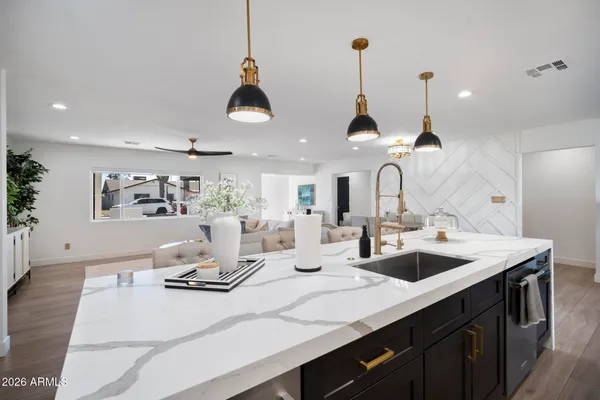 a kitchen with stainless steel appliances kitchen island a sink and cabinets