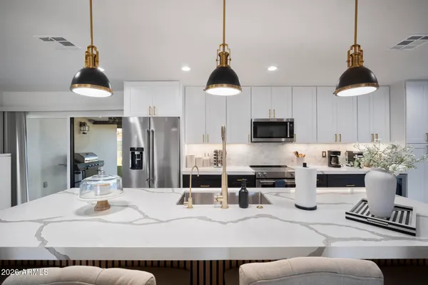 a living room with furniture a chandelier and a flat screen tv