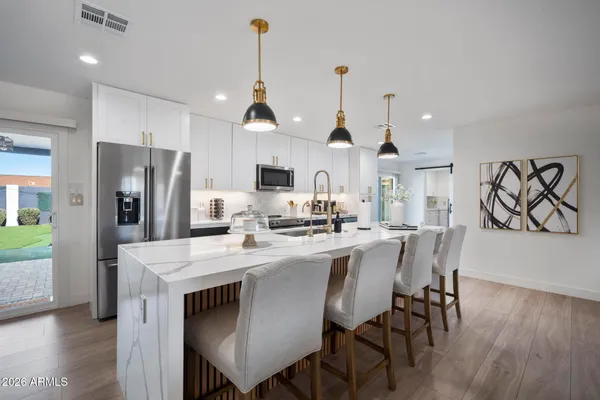 a view of kitchen with cabinets table and chairs