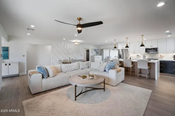 a living room with furniture and kitchen view