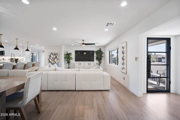 a living room with furniture and wooden floor