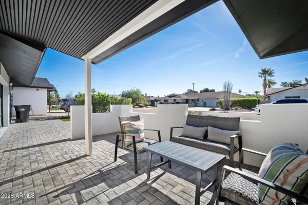 a terrace with outdoor seating and city view