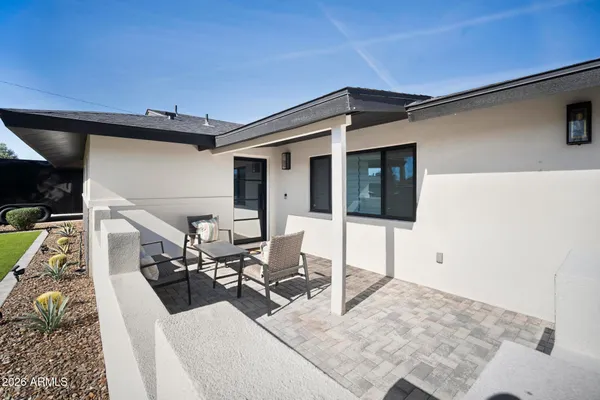 a view of a patio with table and chairs with wooden floor