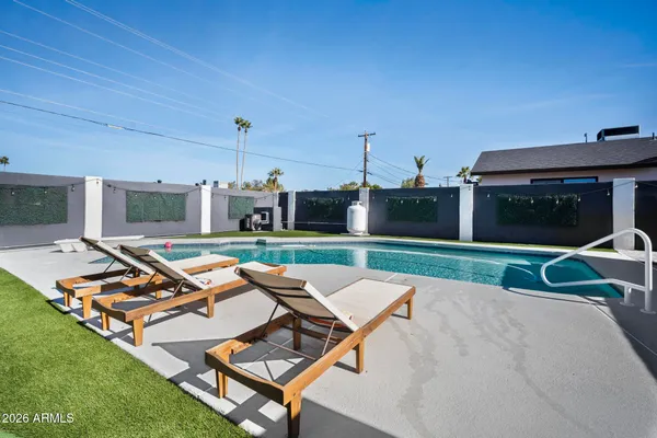 a view of a patio with a table and chairs