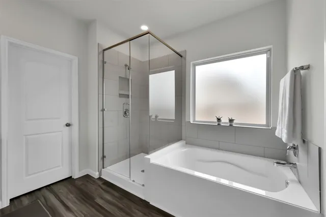 a bathroom with a bathtub and a shower