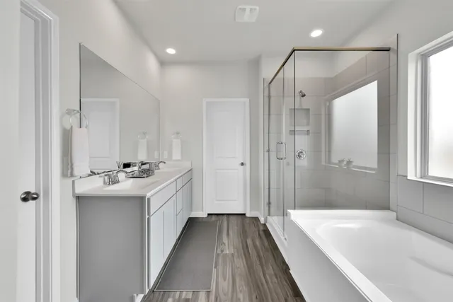 a bathroom with a sink a mirror and a bathtub