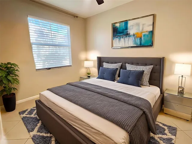 a bedroom with a bed and a painting on the wall