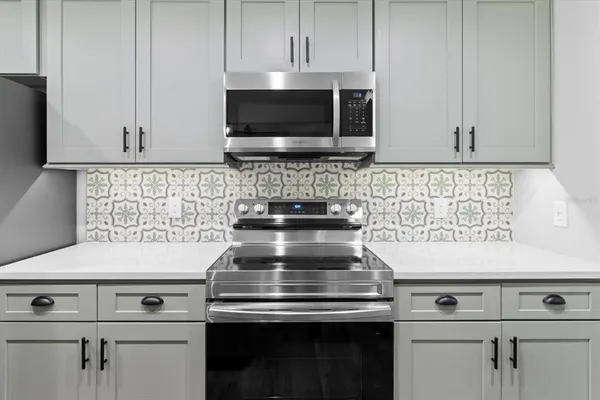 a stove top oven sitting inside of a kitchen
