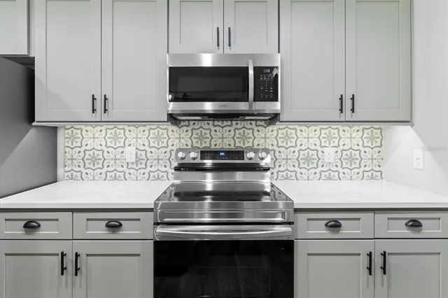 a stove top oven sitting inside of a kitchen