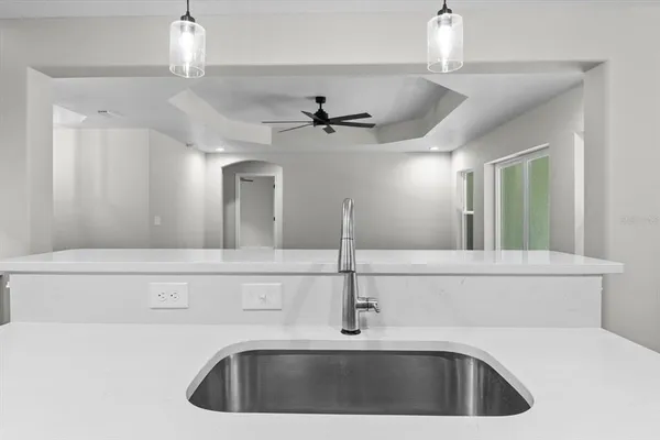 a kitchen with a sink and a chandelier
