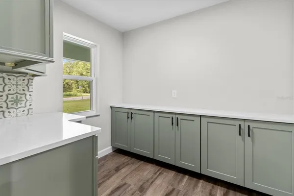 a hallway with a wooden floor and a sink