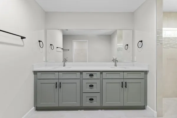 an empty room with wooden floor ceiling fan and windows