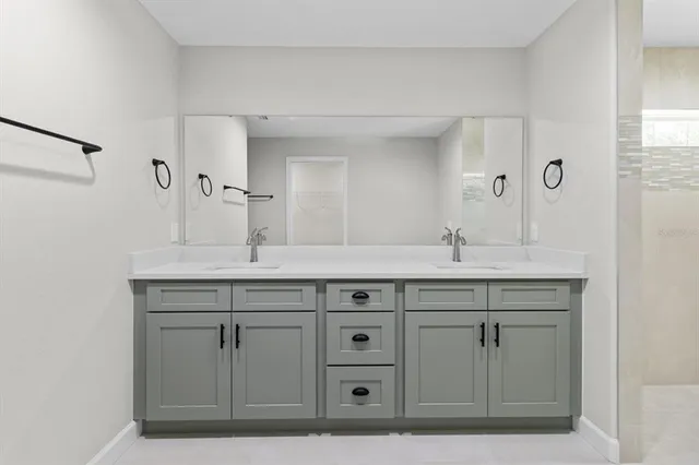 an empty room with wooden floor ceiling fan and windows