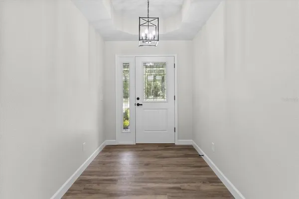 a view of an entryway with wooden floor