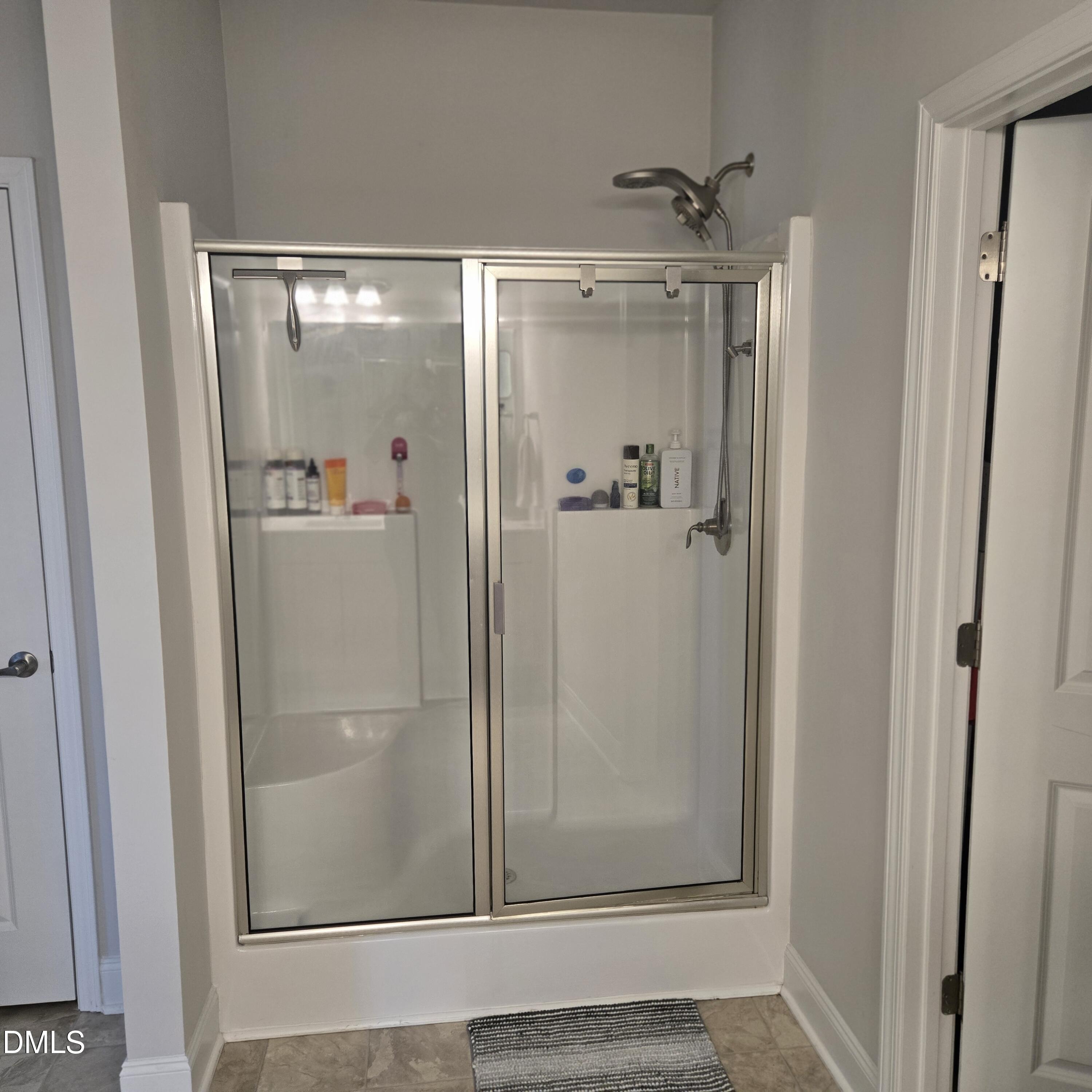 207 Spring Forest Drive Goldsboro, NC 27534 - Photo 12 of 19 a bathroom with a glass shower door and mirror