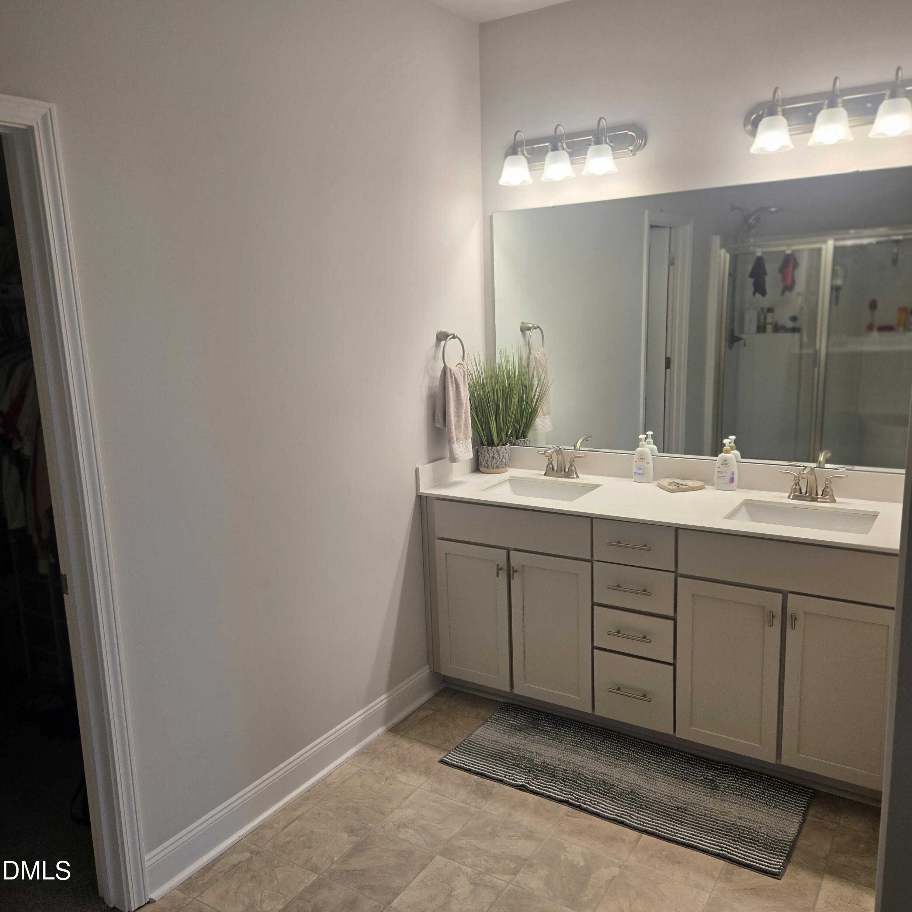 207 Spring Forest Drive Goldsboro, NC 27534 - Photo 13 of 19 a bathroom with a double vanity sink and a mirror
