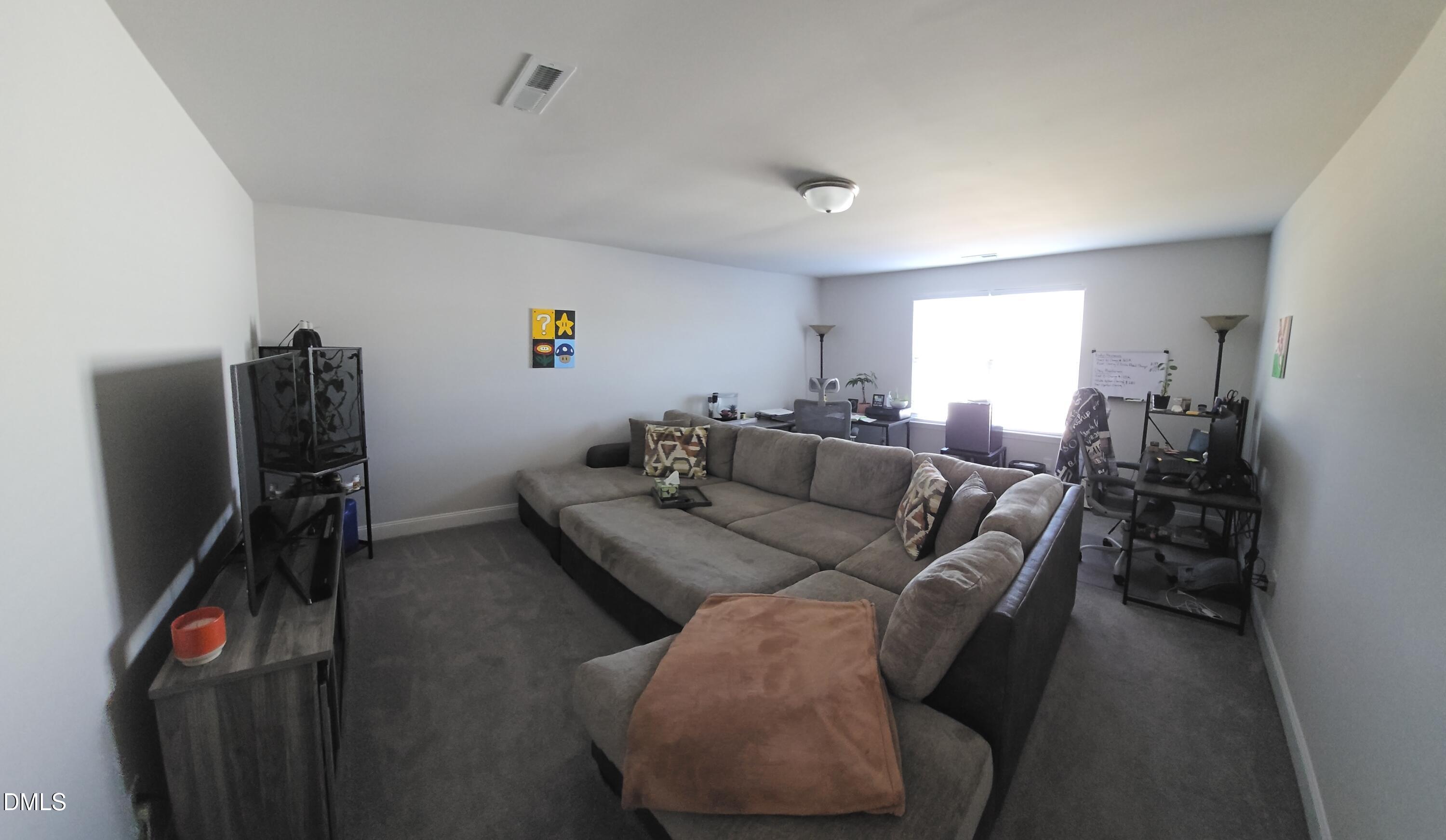 207 Spring Forest Drive Goldsboro, NC 27534 - Photo 15 of 19 a living room with furniture and a flat screen tv