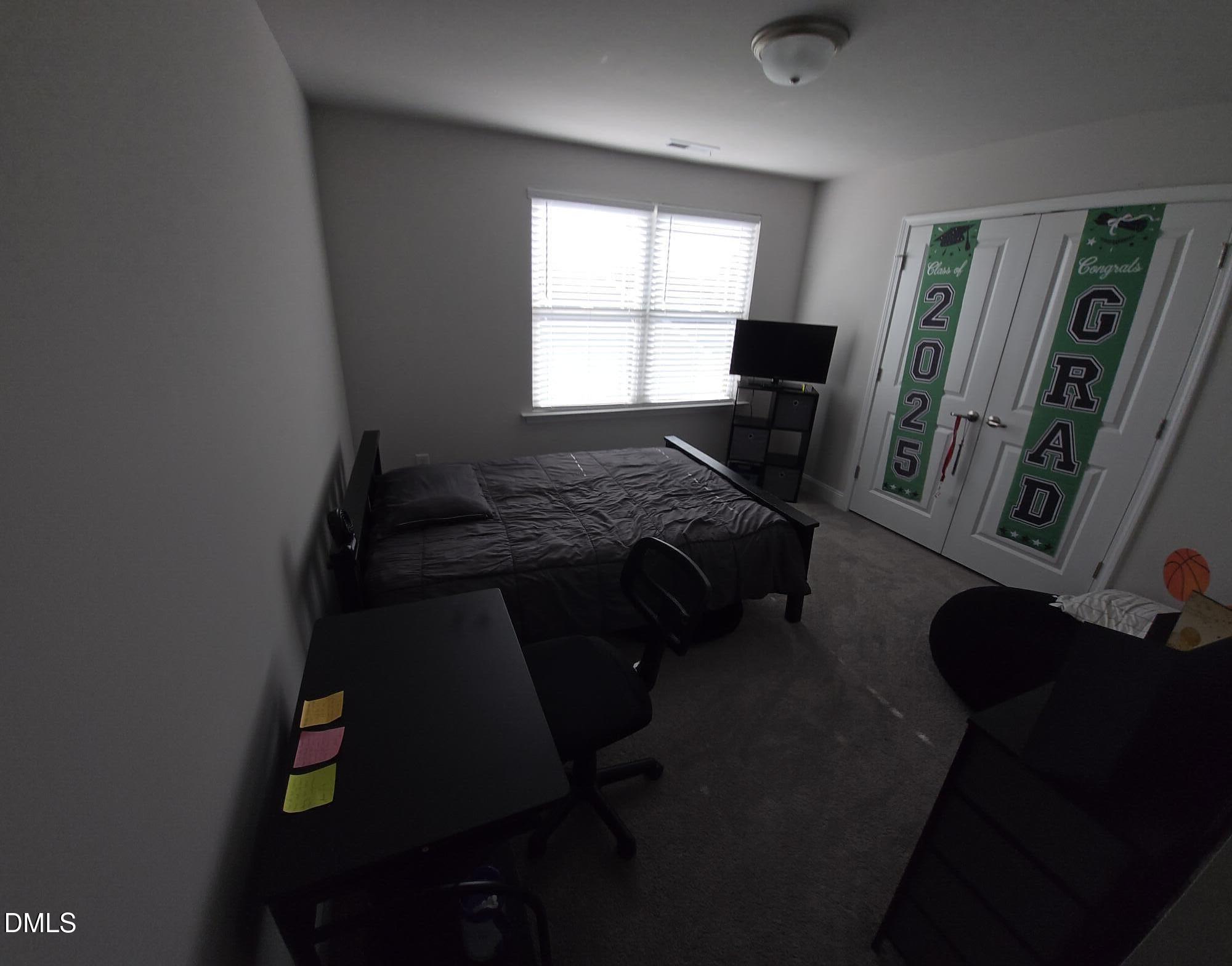 207 Spring Forest Drive Goldsboro, NC 27534 - Photo 17 of 19 a bedroom with a bed next to a window