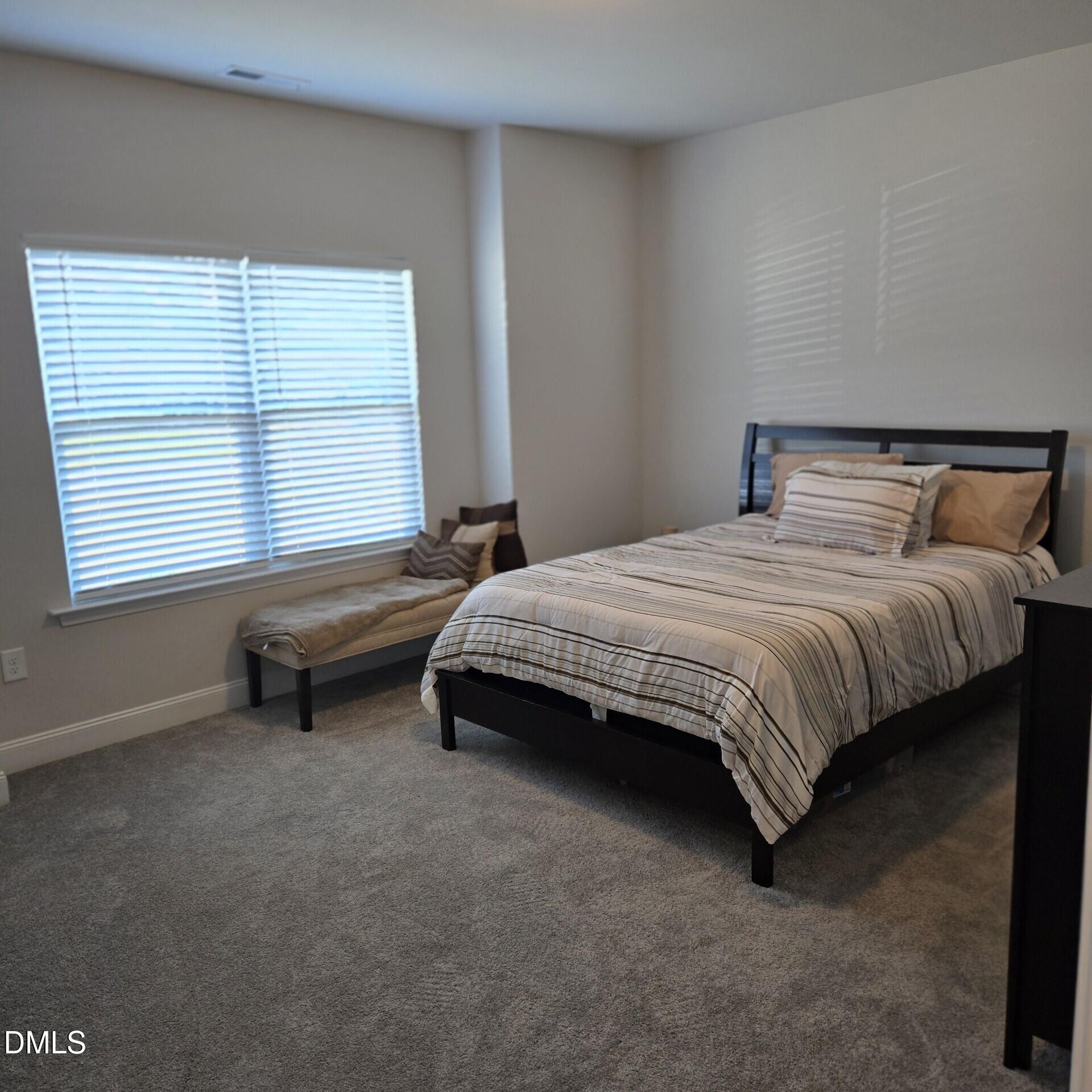 207 Spring Forest Drive Goldsboro, NC 27534 - Photo 5 of 19 a bedroom with a bed and a window