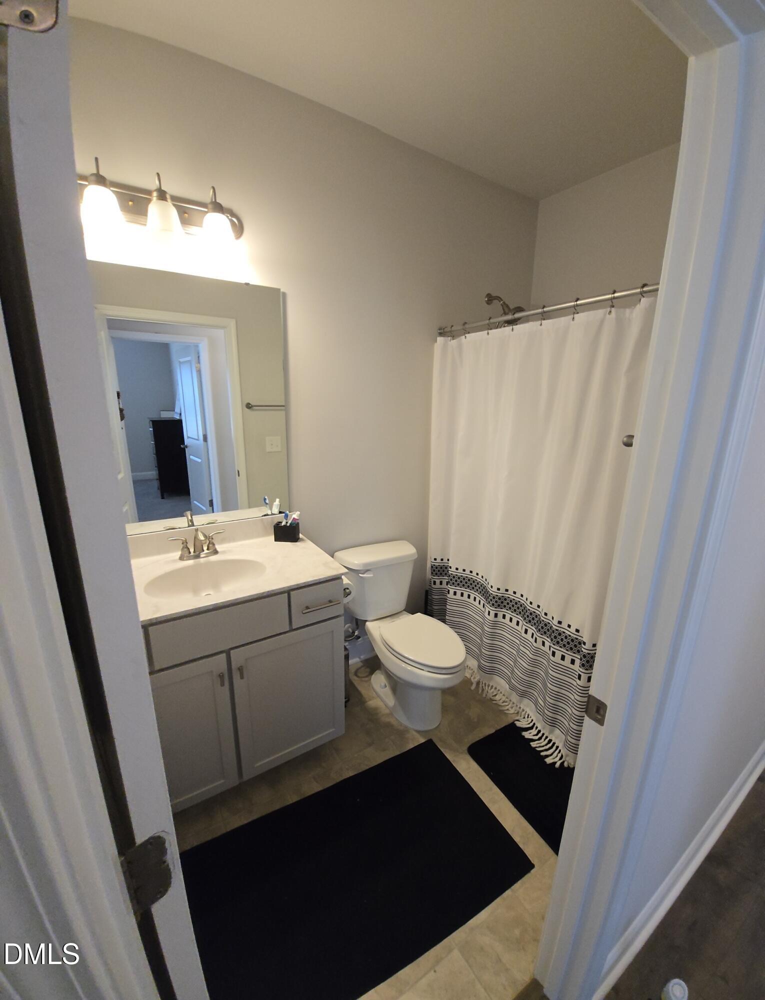 207 Spring Forest Drive Goldsboro, NC 27534 - Photo 7 of 19 a bathroom with a sink and a mirror